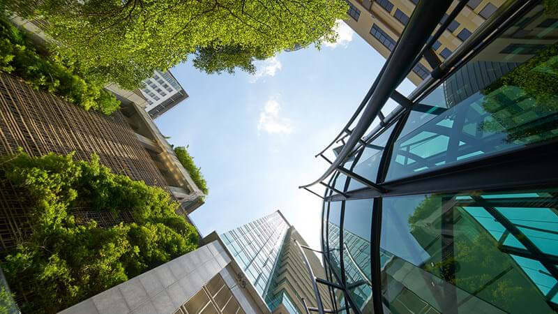 A view of a city with tall buildings and trees.