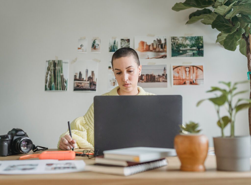 A woman working on her laptop in her home office