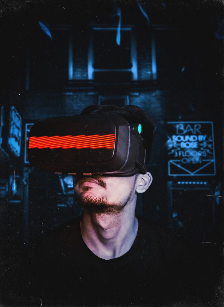 A man wearing a vr headset in a dark environment.