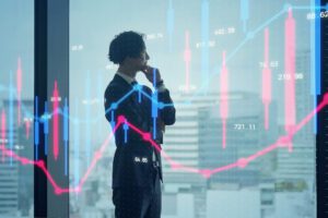 Fintech business person analyzing financial graphs projected on a glass window.